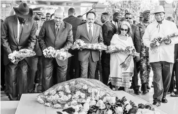  ?? — AFP photo ?? Kiir (left), Sudan’s President Omar al-Bashir (second left), Mohamed (centre), Ethiopia’s President Sahle-Work Zewde (second right) and Museveni (right) offer flowers during a peace ceremony at The John Garang Mausoleum in Juba, South Sudan.