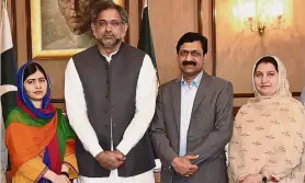  ??  ?? Home sweet home: Malala (left) and her parents with Pakistan Prime MInister Shahid Khaqan Abbasi (second from left) in Islamabad. — AP