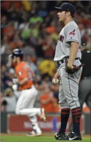  ?? ERIC CHRISTIAN SMITH — THE ASSOCIATED PRESS ?? Indians starting pitcher Trevor Bauer looks on as the Astros’ Josh Reddick rounds the bases after hitting a solo home run during the third inning on May 19.