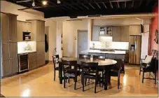  ??  ?? The kitchen has been updated with quartz countertop­s, stainless-steel appliances, pantry cabinets and a large island. Beverage station has wine-cooler and pantry cabinets. The dining room has space for a large table setting and a wall has a beverage station.