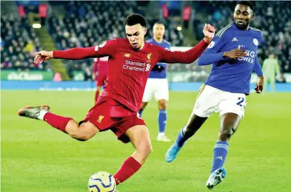  ?? AP ?? Liverpool’s Trent Alexander-Arnold (left) shoots on goal ahead of Leicester City’s Wilfred Ndidi during their English Premier League match at the King Power Stadium in Leicester, England, on Thursday.