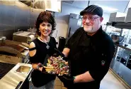  ?? The Sentinel-Record/Richard Rasmussen ?? ■ The Ohio Club co-owner Dona Pettey, left, and Chef Michael Dampier display a dish of Landslide Fries at the club on Thursday.