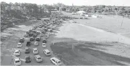  ?? REBECCA BLACKWELL/AP ?? In this photo taken by a drone, cars wait in long lines at a drive-up COVID-19 testing center at Tropical Park, Dec. 29, in Miami.