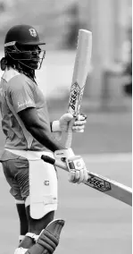  ??  ?? West Indies’ Chris Gayle holds a couple of bats during a training session ahead of their second One-Day Internatio­nal cricket match against India in Port-ofSpain, Trinidad, yesterday.