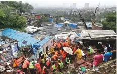  ?? AP ?? ■ Rescuers look for survivors after a wall collapsed on several slum dwellings in Mumbai’s Mahul area.