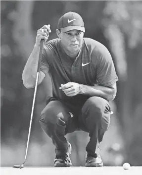  ?? JEFF CURRY/USA TODAY SPORTS ?? Tiger Woods lines up a putt on the 10th green during the final round of the PGA Championsh­ip.