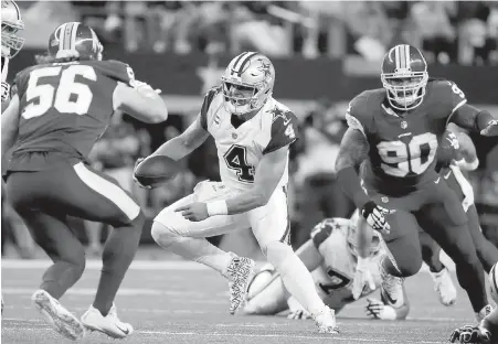  ?? AP ?? Redskins’ Zach Vigil (56) and Ziggy Hood (90) force Dallas Cowboys quarterbac­k Dak Prescott (4) to scramble out of the pocket Thursday.