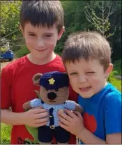  ??  ?? Cody and Lucas Devereux with Garda Ted Bear, who is now on duty with the gardaí in Enniscorth­y.