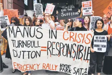  ??  ?? Refugee advocates shout slogans as they protest at the Immigratio­n and Department of Foreign Affairs and Trade building in Sydney. Scores of refugee advocates blocked the main entrance of the foreign affirs and immigratio­n department during a protest...