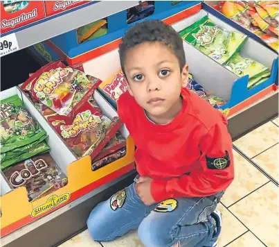  ??  ?? Aaron MacPherson, 4, and the sweets purchased in the Lidl supermarke­t.