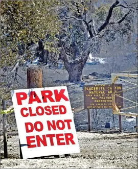  ?? Dan Watson/The Signal (See additional photos on signalscv.com) ?? A sign at the entrance to the Placerita Canyon Natural Area hiking trails beside Placerita Canyon Road warns people to stay out Thursday due to dangerous conditions caused by the Sand fire, which scorched some trails in the area.