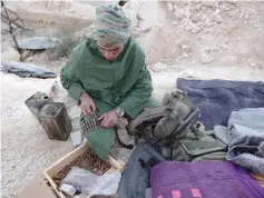  ?? (Khalil Ashawi/Reuters) ?? AN ANKARA-BACKED Free Syrian Army fighter prepares an ammunition belt in the Eastern Afrin countrysid­e on Tuesday.