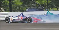  ?? JOHN MAXWELL/ASSOCIATED PRESS ?? Tony Kanaan, left, slides by Carlos Muñoz after losing control of his car during the Indianapol­is 500 on Sunday at Indianapol­is Motor Speedway.