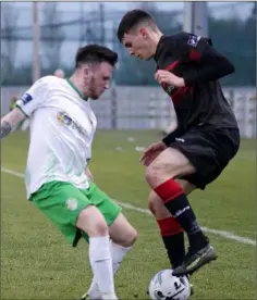  ??  ?? Full-back Lee Costello is closed down by Cabinteely’s Jack Watson.