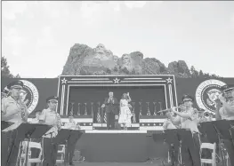  ?? ALEX BRANDON/AP ?? President Donald Trump, accompanie­d by first lady Melania Trump, stand during a July 3 ceremony at Mount Rushmore National Memorial near Keystone, South Dakota.