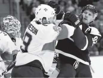  ??  ?? Florida defenseman Michael Matheson gets into a scrum with Colorado forward Gabe Landeskog in front of the Panthers’ net during the first period of their Friday night game at the Pepsi Center.