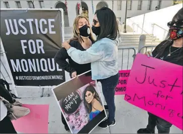  ?? Genaro Molina Los Angeles Times ?? LORETTA CRESPIN, left, mourns the loss of her niece Monique Munoz at a rally in front of L.A. County Dist. Atty. George Gascón’s office. Munoz was killed in February when a speeding Lamborghin­i hit her vehicle.