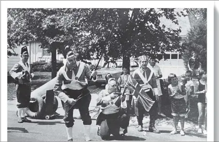  ?? VIRGINIA BORGMAN PHOTOS / TNS ?? The Red Coats fired a few volleys during a Fourth of July reenactmen­t in a Kansas City, Mo., neighborho­od in the mid-1960s, then scattered like chickens. The crowd dispersed to a small park for games, including the ever-popular egg toss, and refreshmen­ts.
