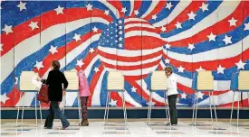  ?? [PHOTOS BY ALEXA WELCH EDLUND/RICHMOND TIMES-DISPATCH VIA AP] ?? People vote at Robious Elementary School on Election Day on Tuesday in Midlothian, Va., with a mural that art educator Andrew R Woodward designed and students created for Veterans Day as a backdrop.