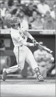  ?? NWA Democrat-Gazette/BEN GOFF • @NWABENGOFF ?? Casey Martin, Arkansas third baseman, hits an infield single in the third inning.