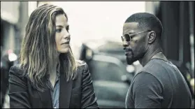  ?? ERICA PARISE/OPEN ROAD FILMS ?? Michelle Monaghan and Jamie Foxx star in “Sleepless,” in which Foxx stars as a Las Vegas police officer who may or may not be a good guy.