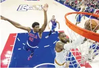  ?? AP ?? Cavaliers’ LeBron James (right), goes up for the shot as 76ers’ Joel Embiid tries to block. —