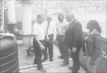  ??  ?? Minister of Natural Resources Raphael Trotman (second, from right) along with General Manager of the Guyana Gold Board Eondrene Thompson (right), Chairman of the Board GHK Lall (second from left) and Ministry of Natural Resources Communicat­ions Officer Johann Earle (third, from left) speaking to the contractor from ActLab Kevin Gomez yesterday.