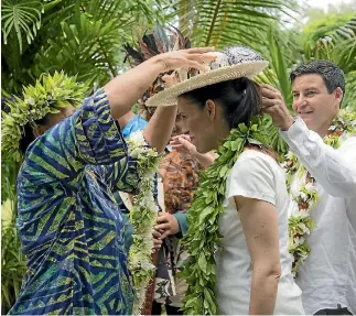  ?? PHOTO: MICHAEL CRAIG/POOL ?? A hat is placed on Prime Minister Jacinda Ardern as she enters Atapare Marae in the Cook Islands.