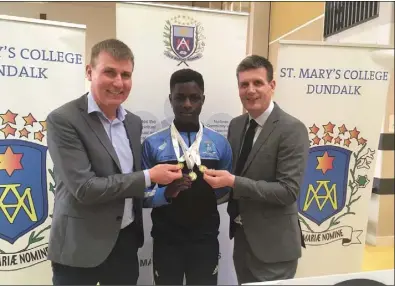  ??  ?? Fifth year student, Israel Olatunde, National Under 15 and Under 20 50metre sprint champion with Dundalk manager, Stephen Kenny and Alan Craven, Principal, St Mary’s College.