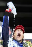  ?? Andy Lyons/Getty Images ?? Takuma Sato celebrates in Victory Lane with a jar of milk in traditiona­l Indianapol­is 500 style.