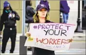  ?? AN EMPLOYEE Bebeto Matthews Associated Press ?? at Amazon’s fulf illment center in Staten Island, N. Y., takes part in a protest in March.