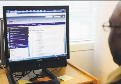  ?? Hearst Connecticu­t Media file photo ?? Ron Miller, former Director of Environmen­tal Inspection­s for the City of Stamford, scrolls through the city’s restaurant reviews website in his office on Feb. 24, 2016.