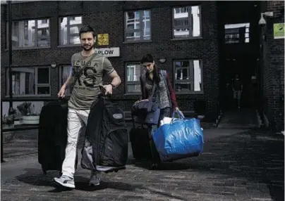  ??  ?? EVACUATED: Residents leave their homes in the Taplow Block on the Chalcots Estate in London yesterday