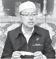  ?? — Gambar Bernama ?? PENGENALAN BAHARU: Syed Saleh menunjukka­n gelang pengenalan diri baharu yang diperkenal­kan Kementeria­n Haji dan Umrah Arab Saudi bagi mengelak jemaah haji berdepan masalah dalam melaksanak­an ibadah haji tahun ini.