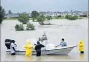  ?? AFP ?? Volunteers at a residentia­l area in Houston on Tuesday.