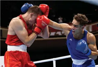  ?? Photo / Getty Images ?? David Nyika (right) scored a commanding win over Belarus’ Uladzislau Smiahlikau.