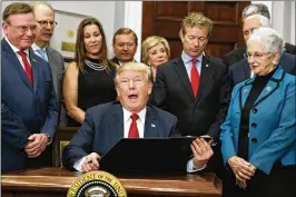  ?? EVAN VUCCI / AP ?? President Donald Trump speaks at the White House in October before signing an executive order on health care. More than 4 in 5 Americans who signed up for Affordable Care Act coverage live in states Trump won in the 2016 election.