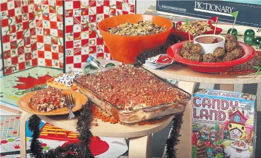  ?? STEVE RUSSELL TORONTO STAR ?? This holiday retro potluck includes Veggie Chickpea Balls with Sweet and Sour Sauce, right, Chop Suey Snack Mix and Seriously Good Tuna Casserole topped with spicy Cheetos.