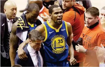  ?? (AP) ?? GOLDEN STATE WARRIORS forward Kevin Durant (35) reacts as he leaves the court after sustaining an injury during first-half basketball action against the Toronto Raptors in Game 5 of the NBA Finals in Toronto, Monday, June 10, 2019.