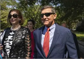  ?? MANUEL BALCE CENETA — THE ASSOCIATED PRESS ?? Michael Flynn, President Donald Trump’s former national security adviser, leaves federal court with his lawyer Sidney Powell, left, in Washington on Tuesday.