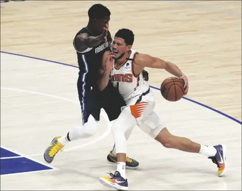  ?? ASSOCIATED PRESS ?? DALLAS MAVERICKS GUARD JOSH RICHARDSON a game on Monday in Dallas. (0) defends against Phoenix Suns guard Devin Booker (1) in the first half during