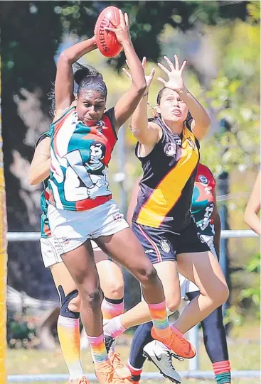  ?? Picture: JUSTIN BRIERTY ?? TOUGH CONTEST: South Cairns’ Kitara Farrar flies high for the ball in front of North Cairns’ playingcoa­ch Luana Healey during their AFL Cairns Womens’ match.