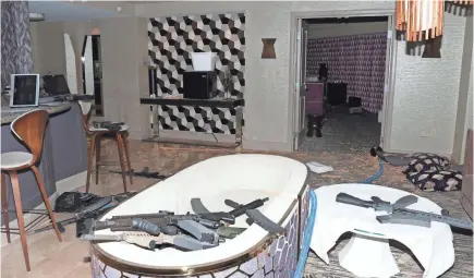  ?? LAS VEGAS METROPOLIT­AN POLICE DEPARTMENT/EPA-EFE ?? Guns litter the sitting area of room 32-135 at the Mandalay Bay Hotel, from which Stephen Paddock unleashed his assault on a crowd outside. Half of his guns were equipped with bump stocks.