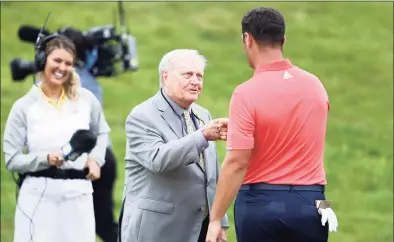  ?? Jamie Squire / Getty Images ?? Jack Nicklaus congratula­tes Jon Rahm on the 18th green after Rahm won during the final round of The Memorial Tournament on July 19 at Muirfield Village Golf Club in Dublin, Ohio.