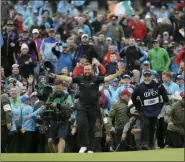  ?? MATT DUNHAM — THE ASSOCIATED PRESS ?? Ireland’s Shane Lowry walks arms outstretch­ed on the 18th green on his way to winning the British Open Golf Championsh­ips at Royal Portrush in Northern Ireland, Sunday.