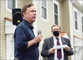  ?? Erik Trautmann / Hearst Connecticu­t Media file photo ?? Gov. Ned Lamont speaks at a Greenwich Communitie­s plaque dedication at its Armstrong Court affordable housing apartment complex in April with Greenwich Communitie­s board Chair Sam Romeo.