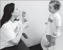  ?? By Doug Kapustin for USA TODAY ?? Big steps but a long way to go: Nicky May, 2, and his mother, Nicole May, take a break at the Center for Autism Research in Philadelph­ia.