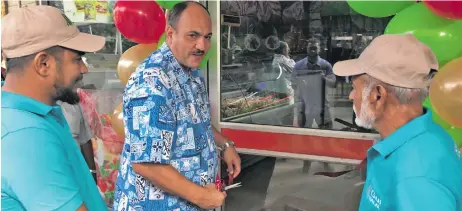  ?? Photo: Waisea Nasokia ?? Nadi Town Council chief executive officer Craig Powell (middle), cuts the ribbon during the official opening of the M Gul Halal Meats butcher shop in Nadi Town on July 3, 2020.