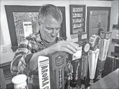  ?? Associated Press ?? Big Sur Taproom and Deli owner Kurt Mayer pours a beer in Big Sur earlier this month. The tap room and deli are the only businesses open in town on the south side of the bridge closure on Highway 1. Mayer has to drive six hours round trip back to...