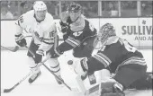  ?? MICHAEL DWYER/AP ?? The Maple Leafs’ Andreas Johnsson, left, looks for the rebound after taking a shot on Bruins goaltender Jaroslav Halak as Torey Krug defends on Saturday.